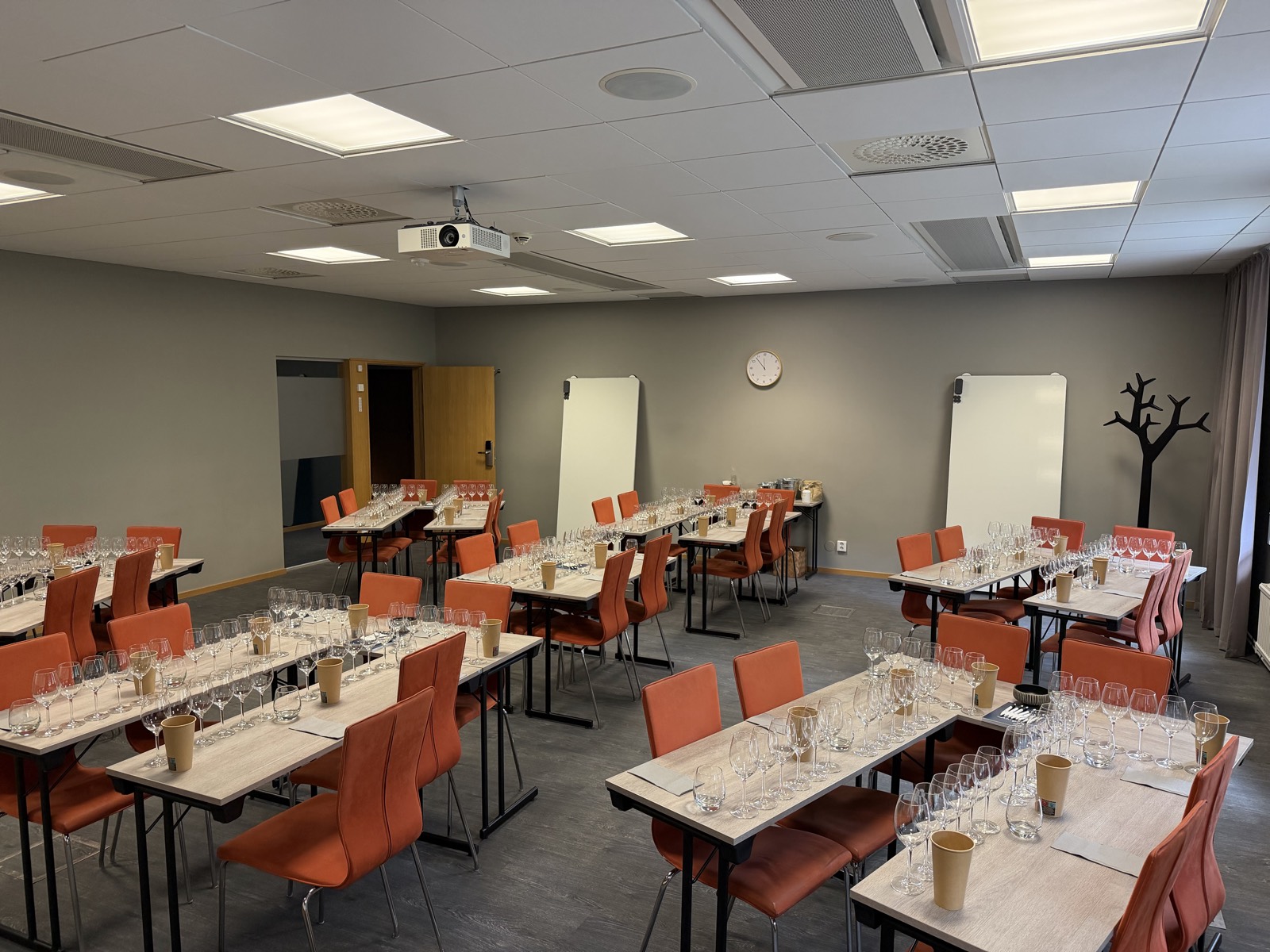 The tasting room at Sånga-Säby set for forty, six glasses and a spittoon at every seat