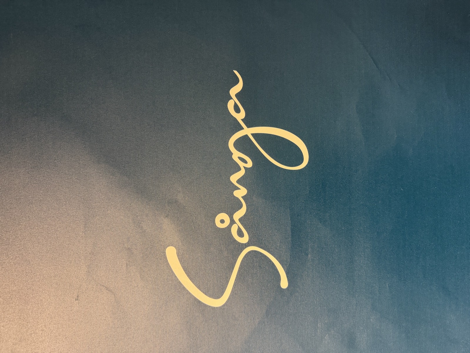 The Sånga-Säby logo in gold on a deep blue wall